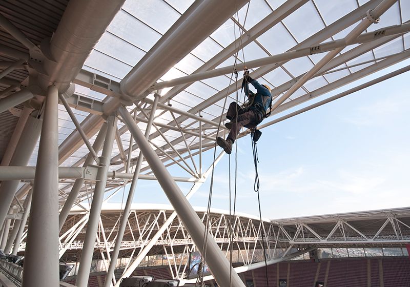 Worker climbing at construction site