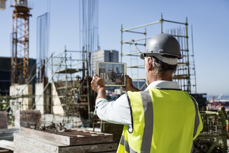 Male architect photographing construction site cm