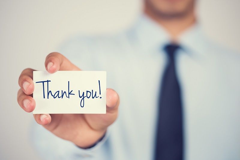 Thank you word on card hold by man cm