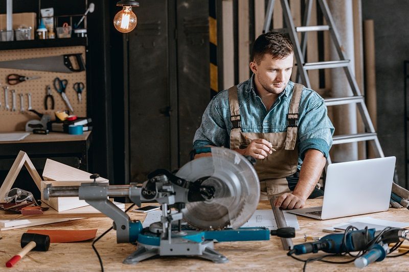 Bearded carpenter planning woodworking project-cm