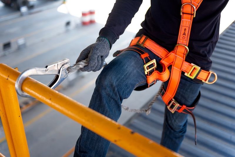 Construction worker use safety harness and safety line working on a new construction site project-cm