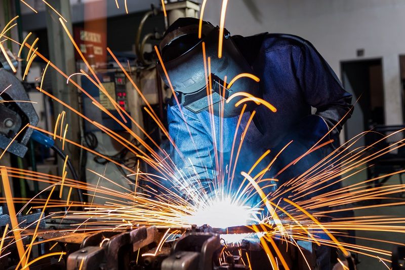 welder is welding assembly car parts in factory with protection mask-cm
