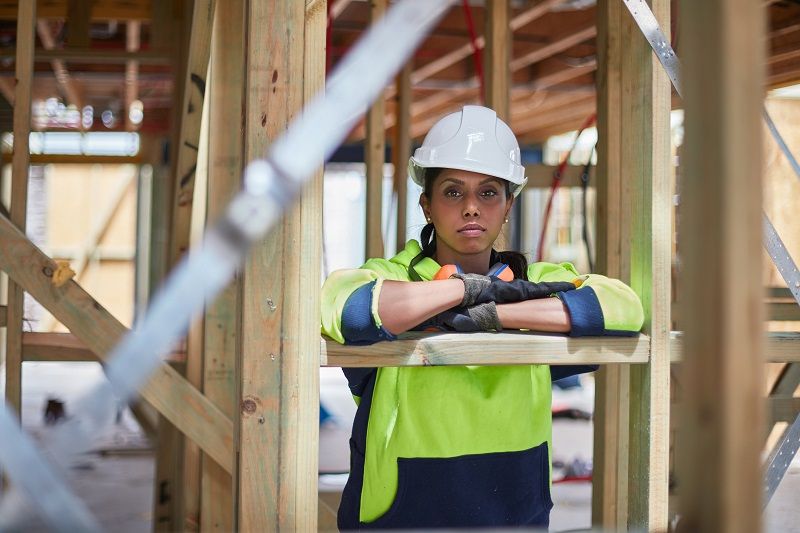 Construction-worker-leaning-on-wooden-plank