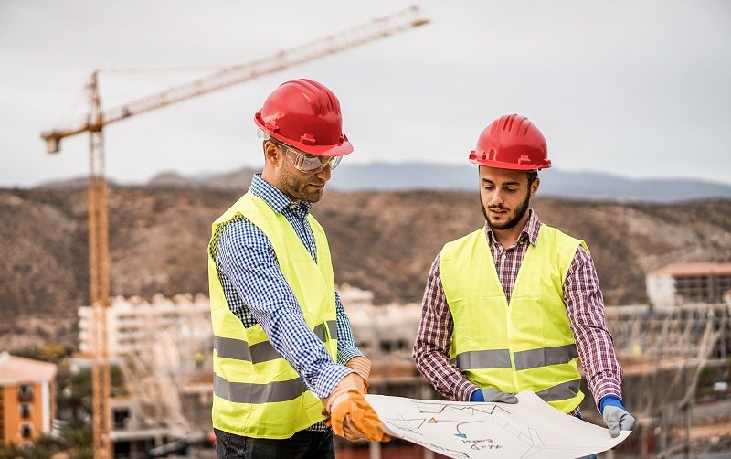 Builders-on-residential-construction-site-looking-the-building-project-cm