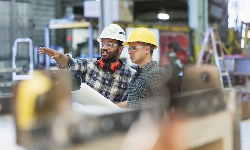Multi-ethnic-workers-talking-in-metal-fabrication-plant--cm