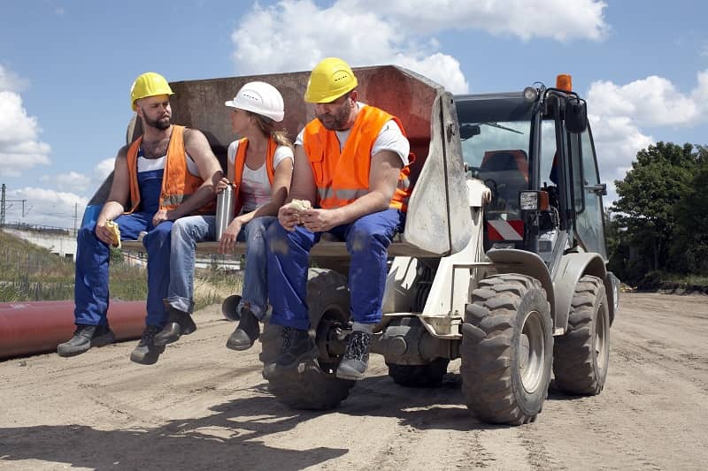 3 construction workers sitting on machinery-cm