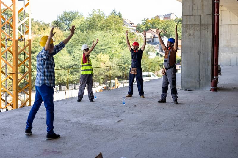 A Group of Multicultural Workers are Exercising During a Work and Stretching a Muscles-cm
