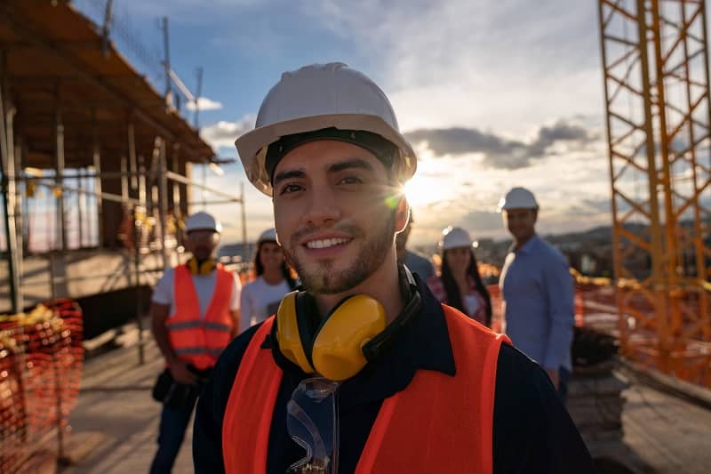 Portrait of a happy construction worker at a building site-cm