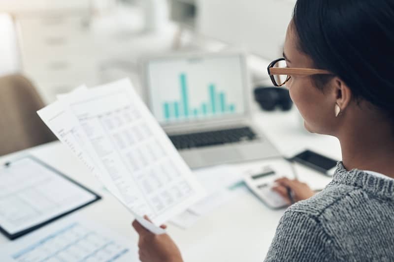 Closeup shot of an unrecognisable businesswoman calculating finances in an office-cm