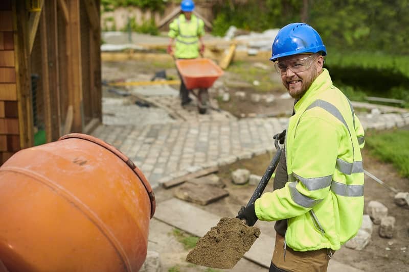 Landscape contractor loading the cement mixer-cm