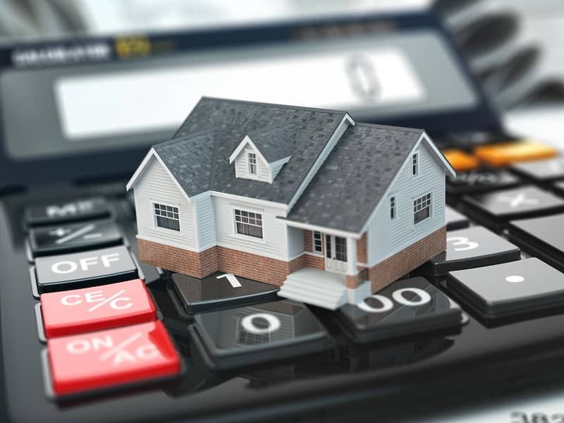 Mortgage calculator. House on buttons. Real estate concept.-cm