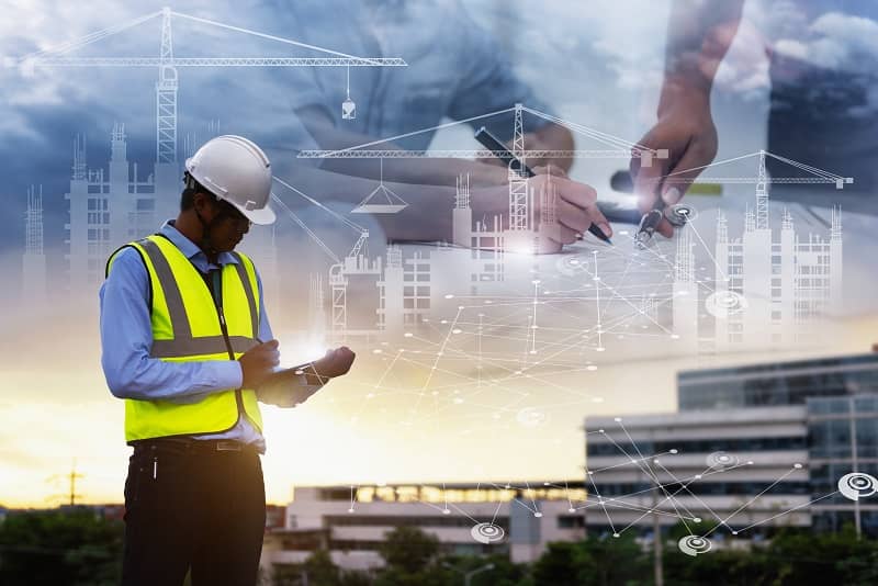 Engineering Consulting People on construction site holding tablet in his hand.-cm