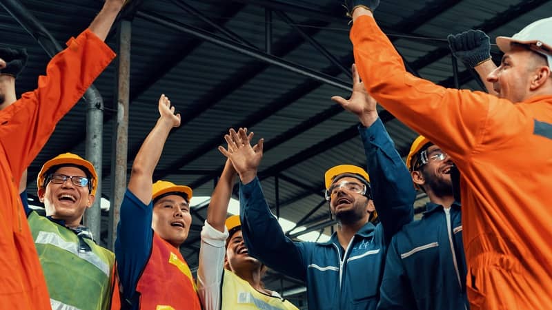 Skillful worker celebrate success in the factory -cm
