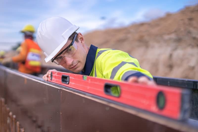 Male engineer check elevation and quality work at construction site-cm