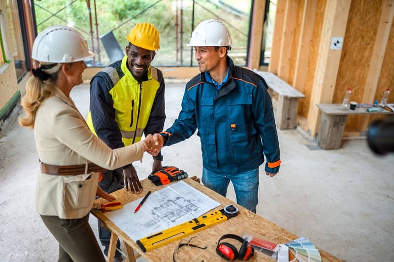 Businesswoman And Contractor Closing A Deal-cm