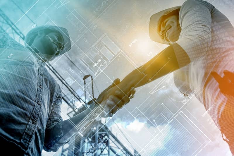 Double exposure of contractors handshaking at a construction site-cm