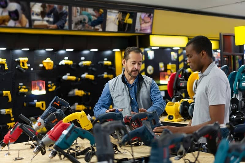 Salesman helping a man buying tools at a hardware store-cm