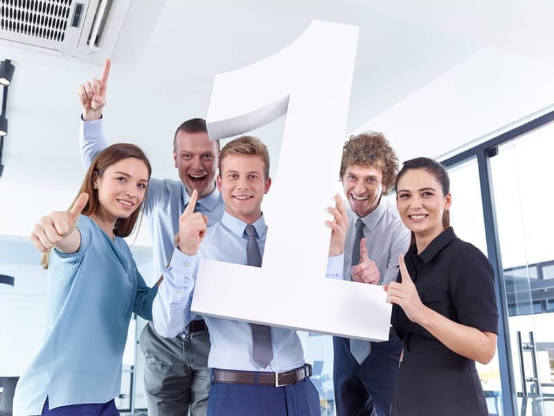 Business people holding large number 1 -cm (1)